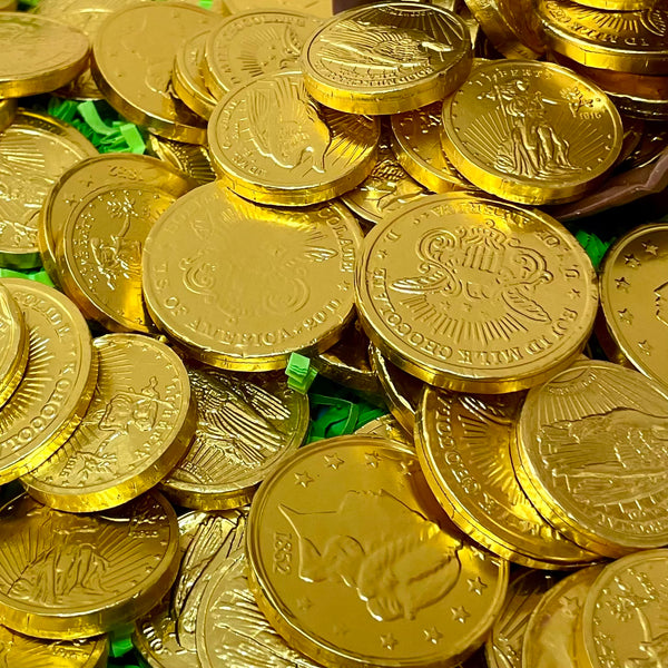 Stack of foil-wrapped chocolate gold coins on a surface